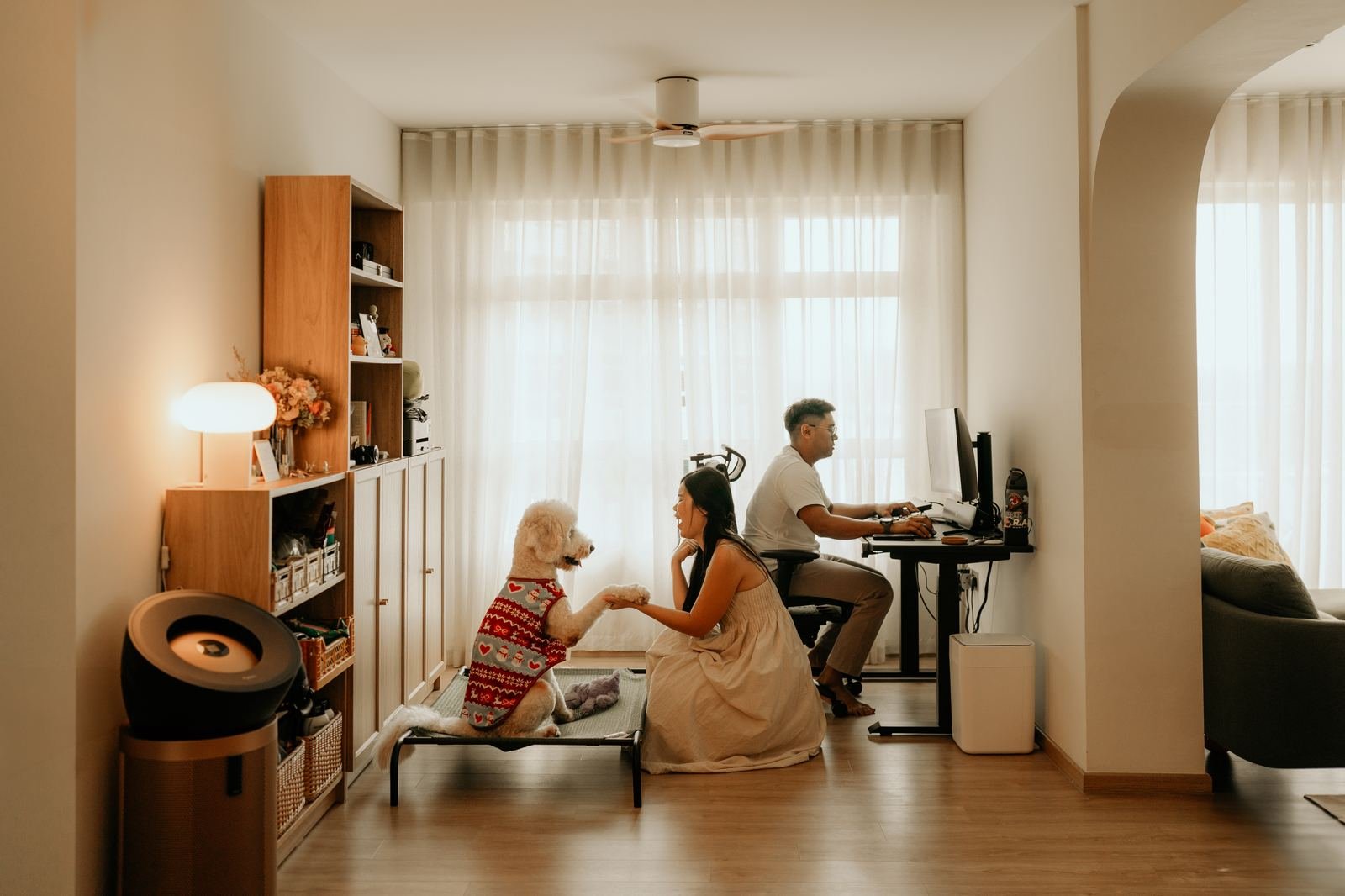 Work-from-home couple with their poodle in a warm living room
