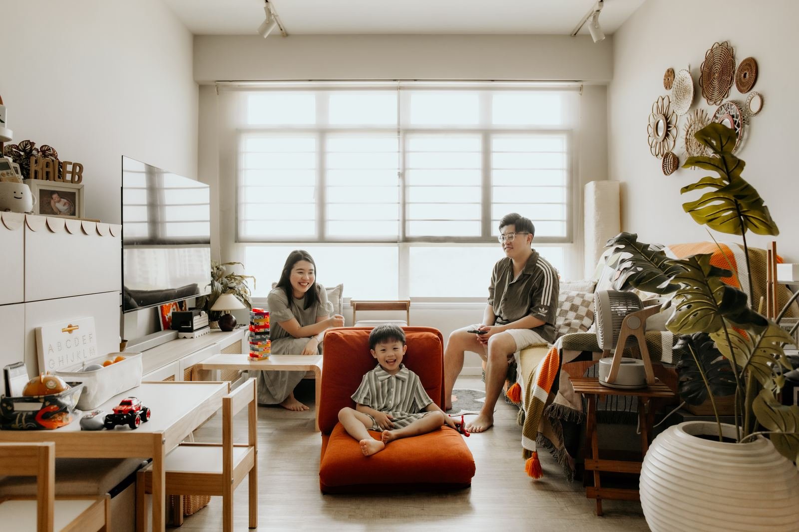 Family playing in bright HDB living room